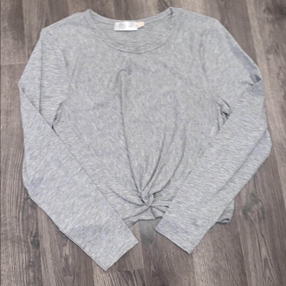 Long sleeve, cropped, gray shirt.